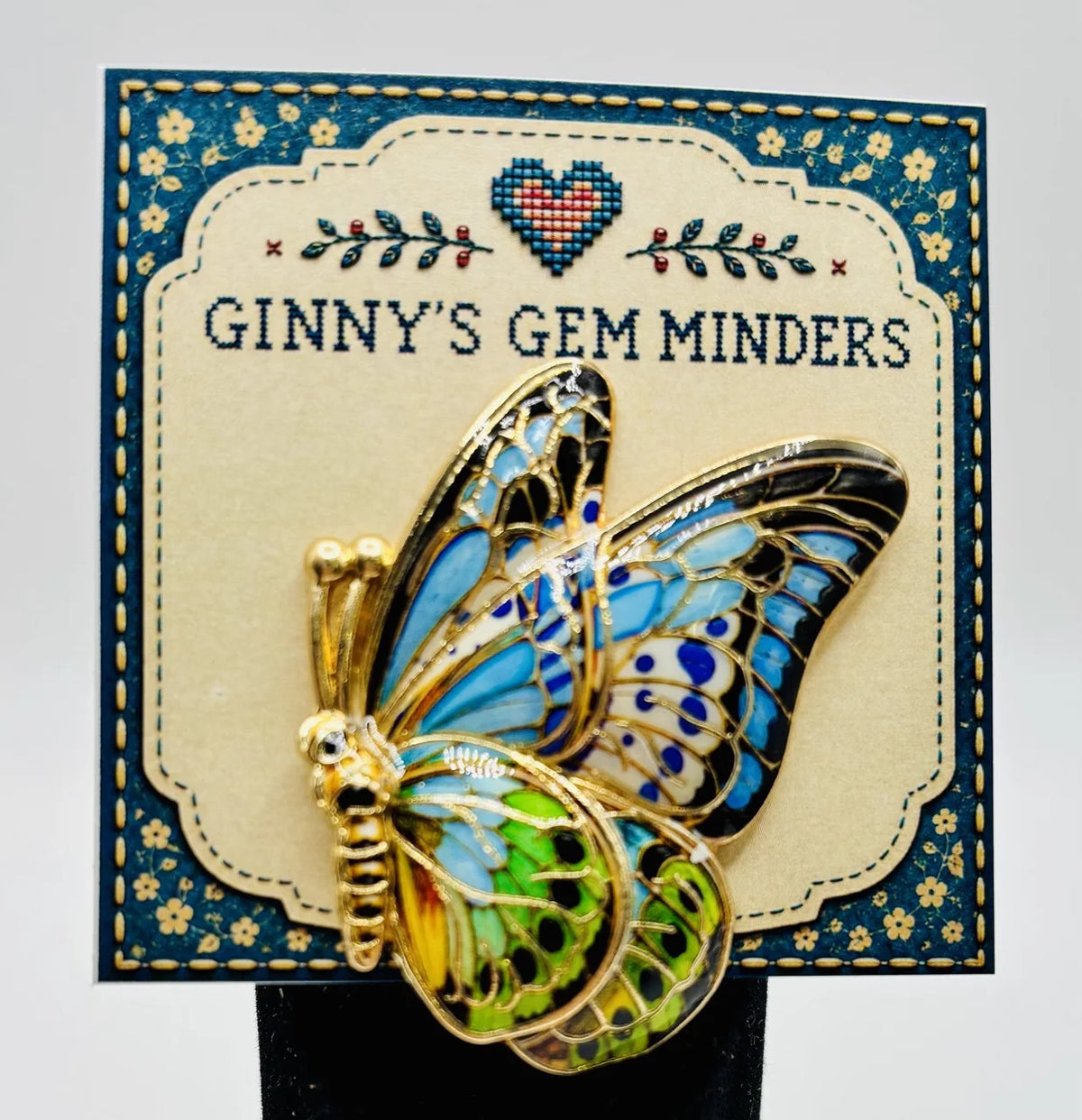Butterfly needle minder on Ginny’s Gem Minders display card