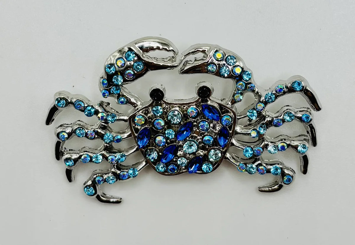 Crystal blue crab needle minder on a white background