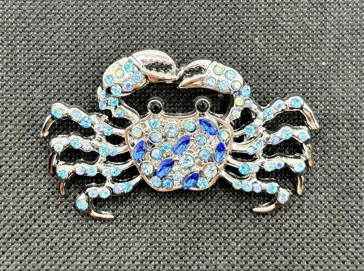 Crystal blue crab needle minder on dark fabric