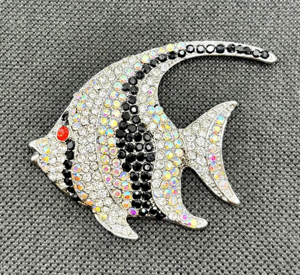 Black and white crystal angelfish needle minder on dark fabric