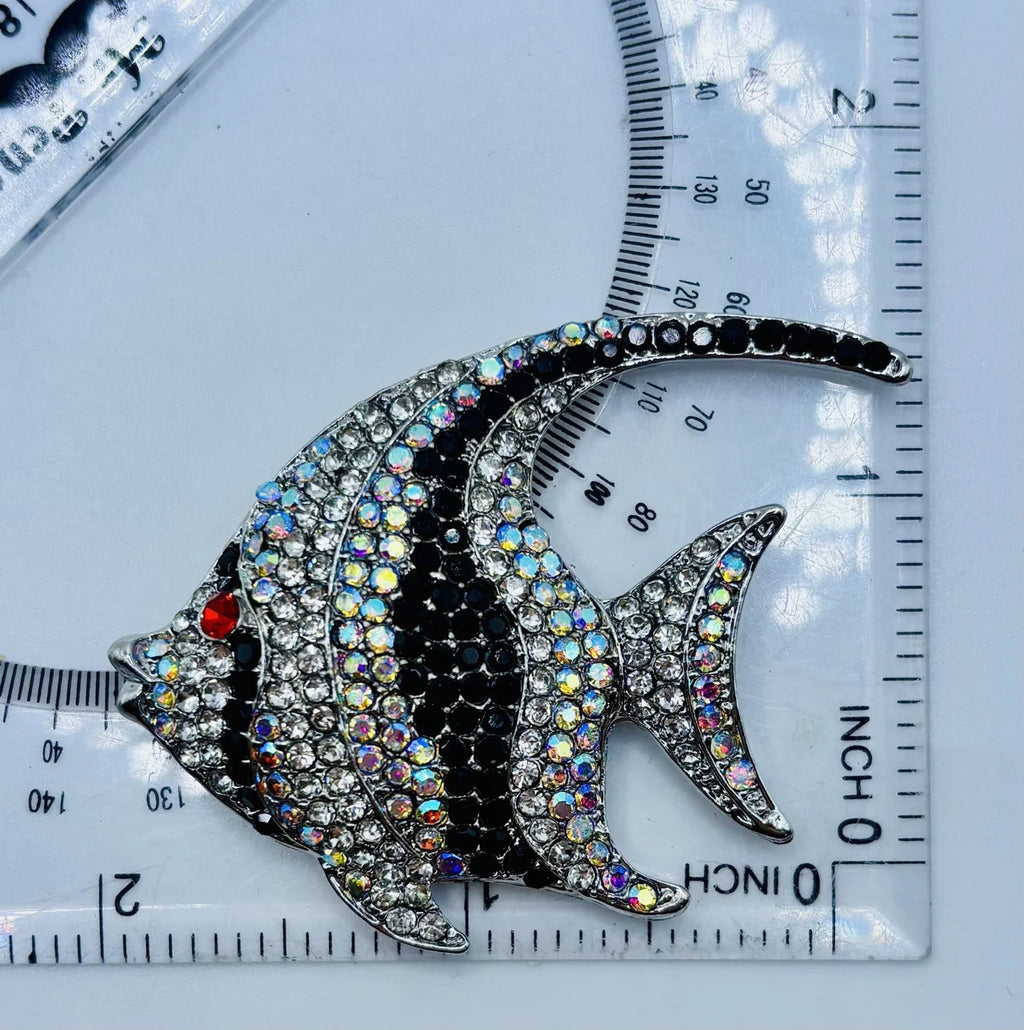 Black and white crystal angelfish needle minder beside a ruler for scale