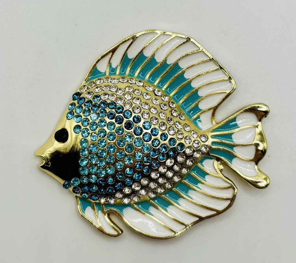 Blue and white crystal discus fish needle minder on a white background