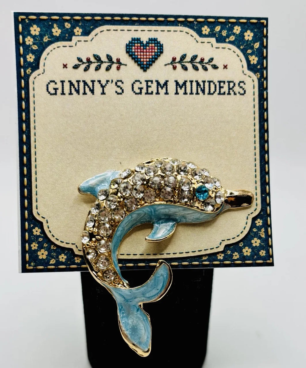Blue crystal dolphin needle minder on Ginny’s Gem Minders display card