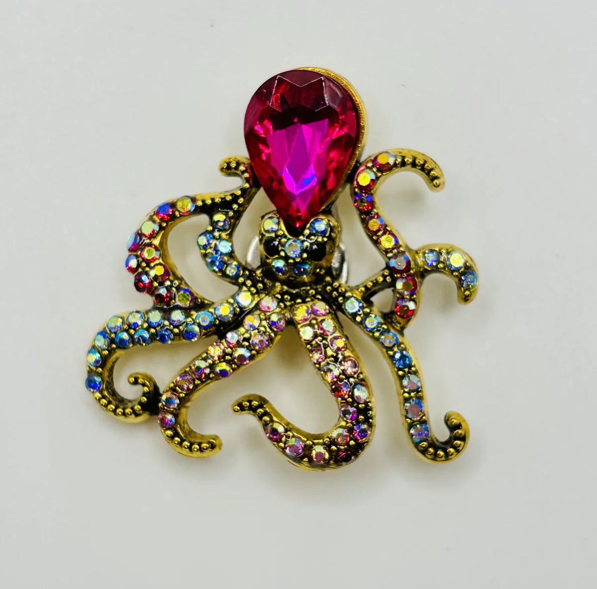 Pink crystal octopus needle minder on a white background
