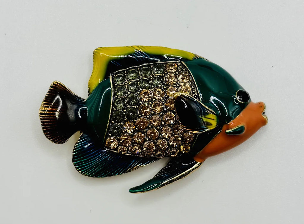 Colorful enamel and crystal tropical fish needle minder on a white background