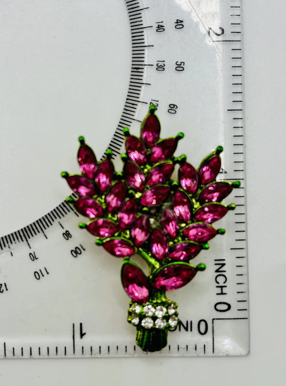 Pink crystal tall flowers needle minder beside a ruler for scale