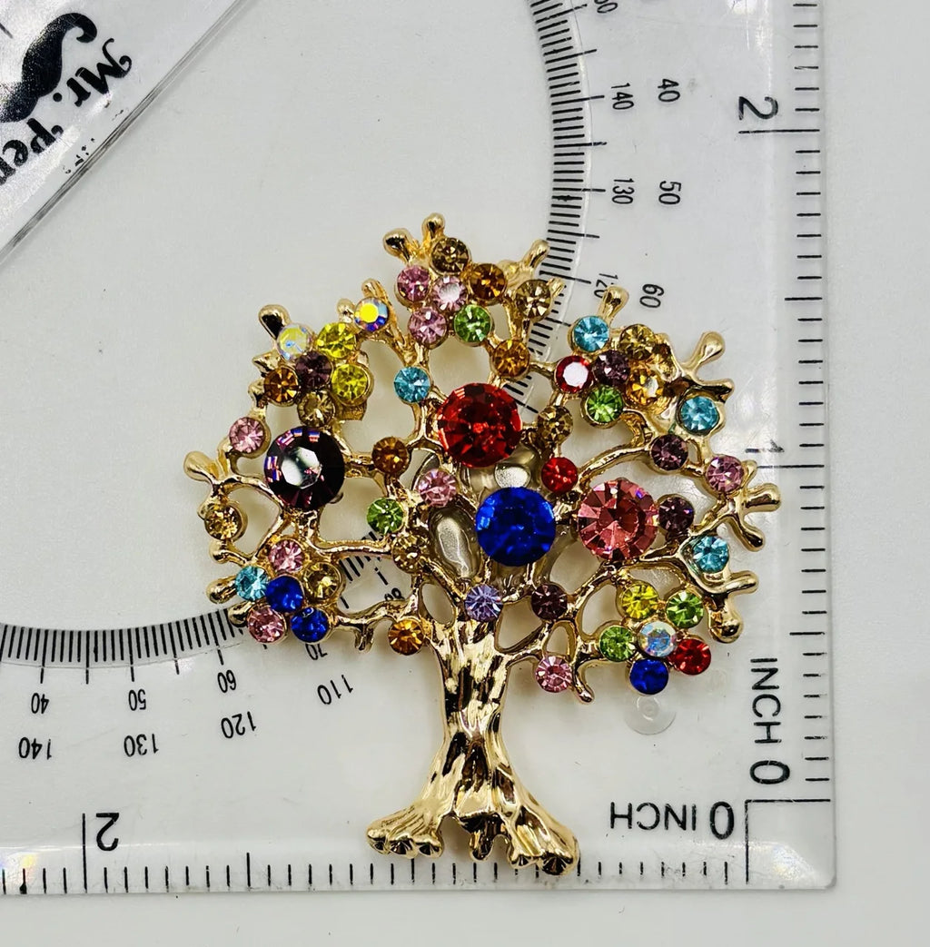 Colorful tree of life needle minder beside a ruler for scale