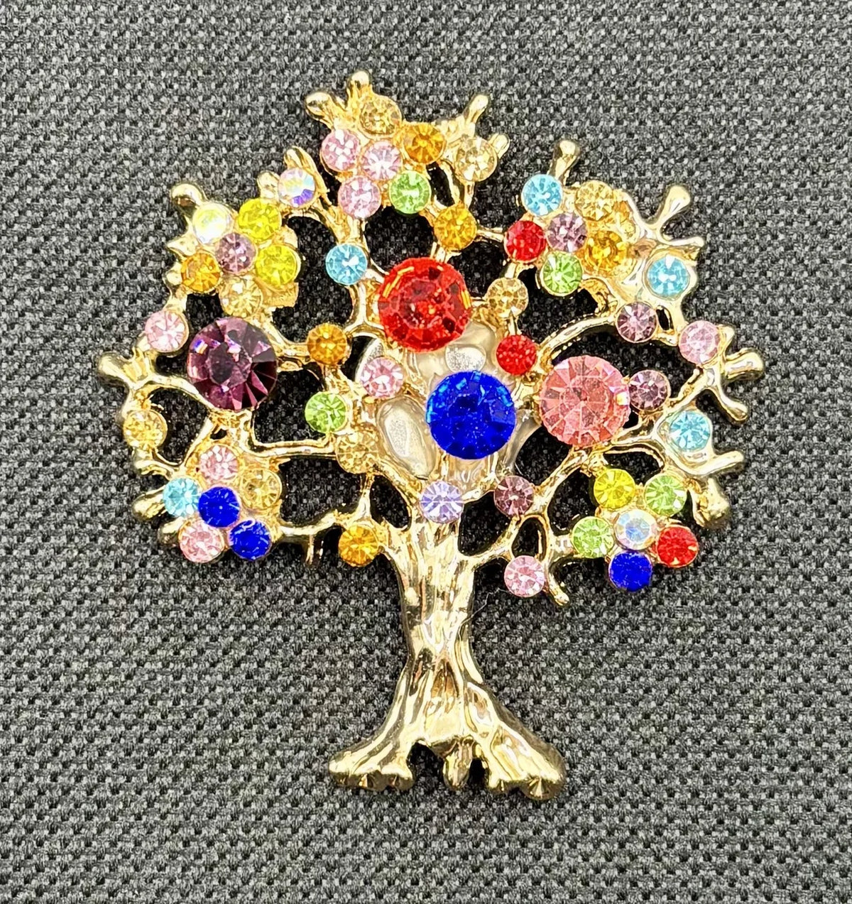 Colorful tree of life needle minder on dark fabric
