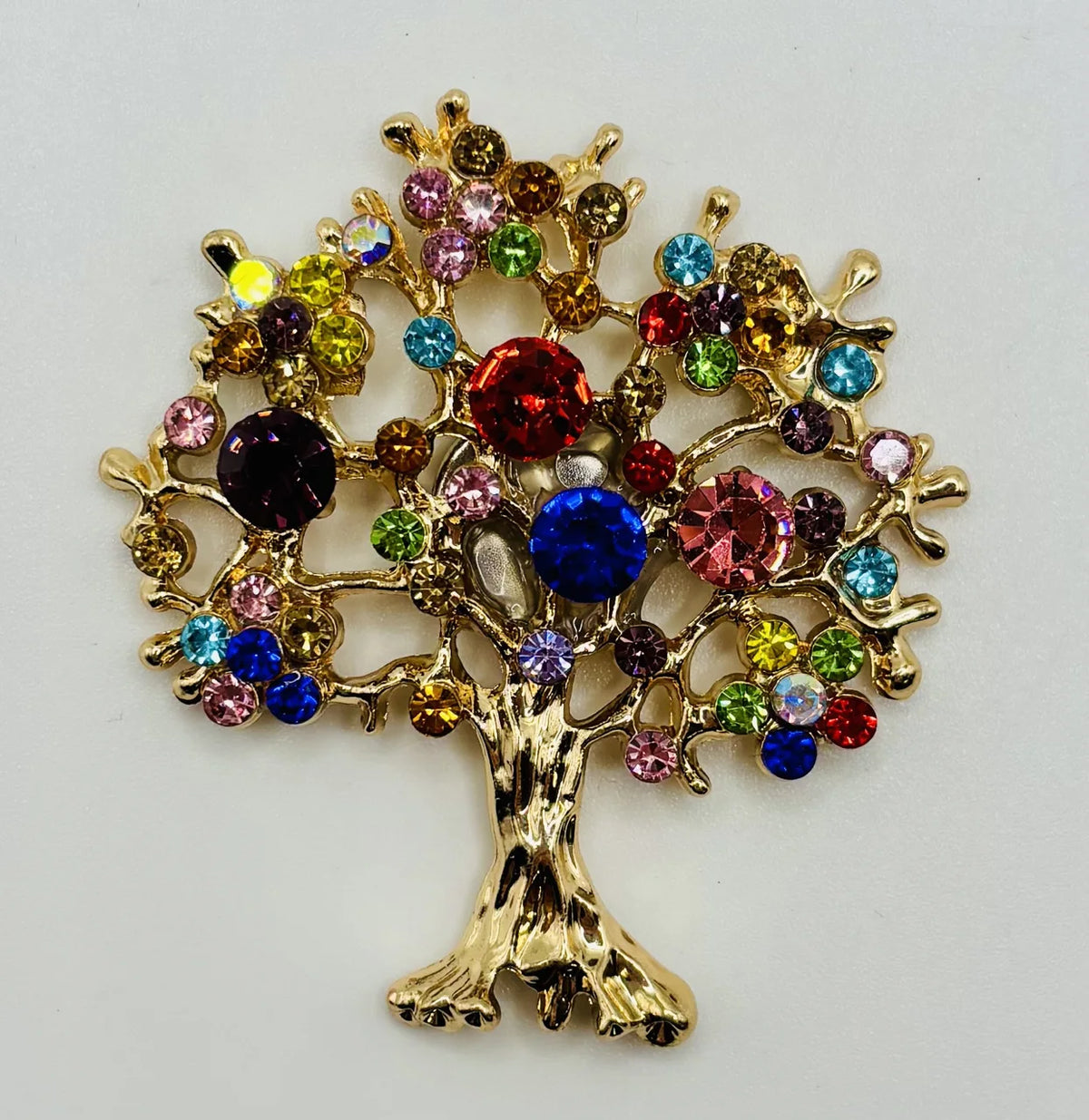 Colorful tree of life needle minder on a white background