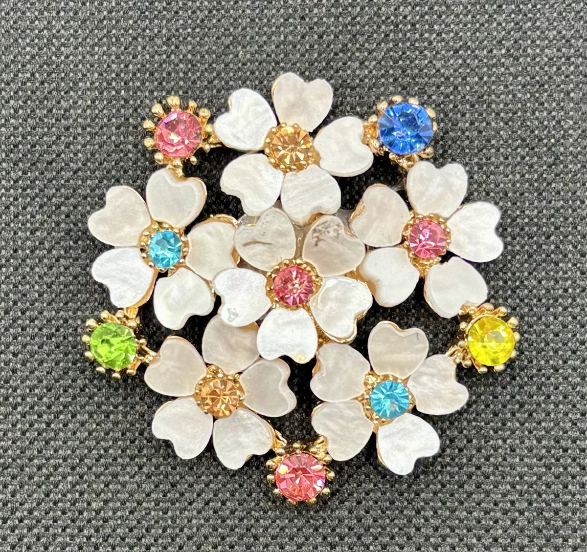 Crystal white posey needle minder on dark fabric
