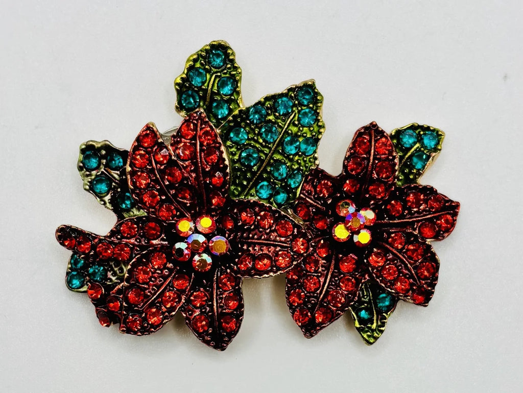 Crystal red poinsettia needle minder on a white background