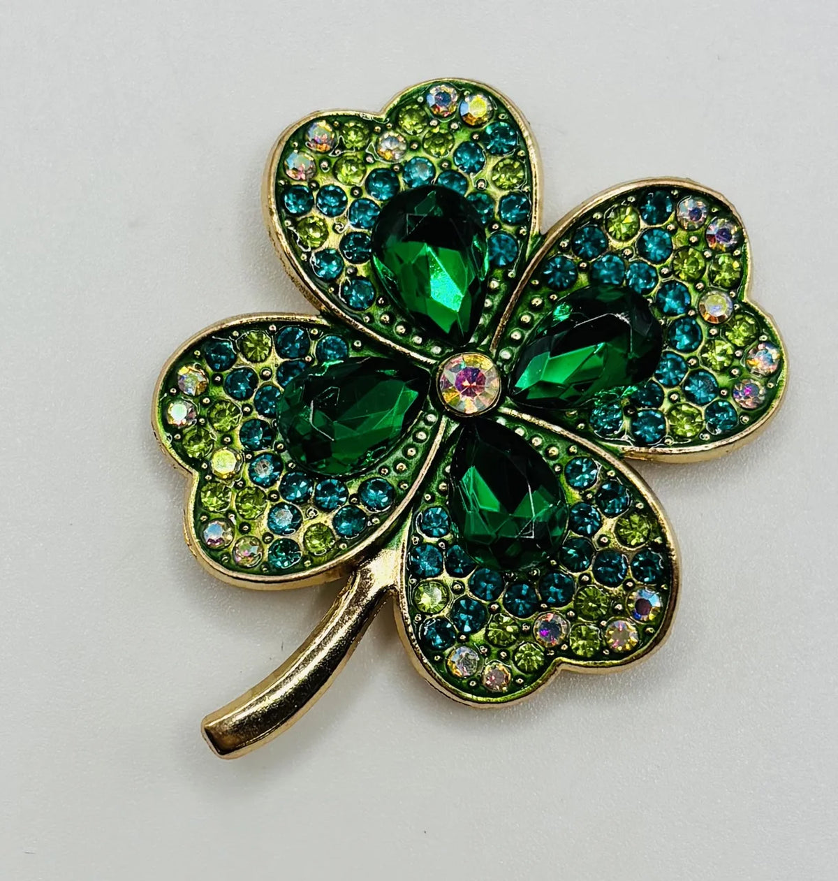 Large crystal shamrock needle minder on a white background