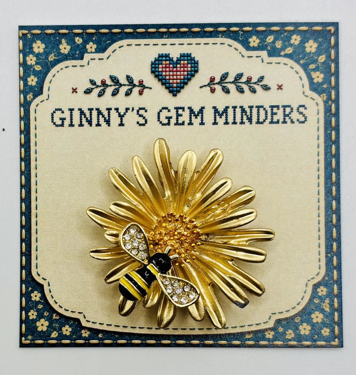 Enamel daisy with bee needle minder on Ginny’s Gem Minders display card