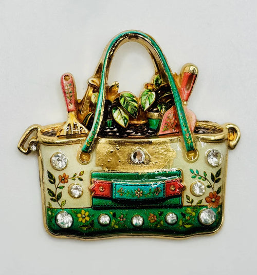 Enamel and crystal gardeners tote needle minder on a white background