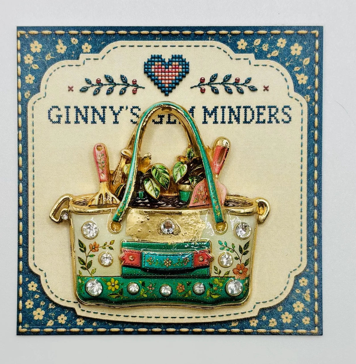 Enamel and crystal gardeners tote needle minder on Ginny’s Gem Minders display card