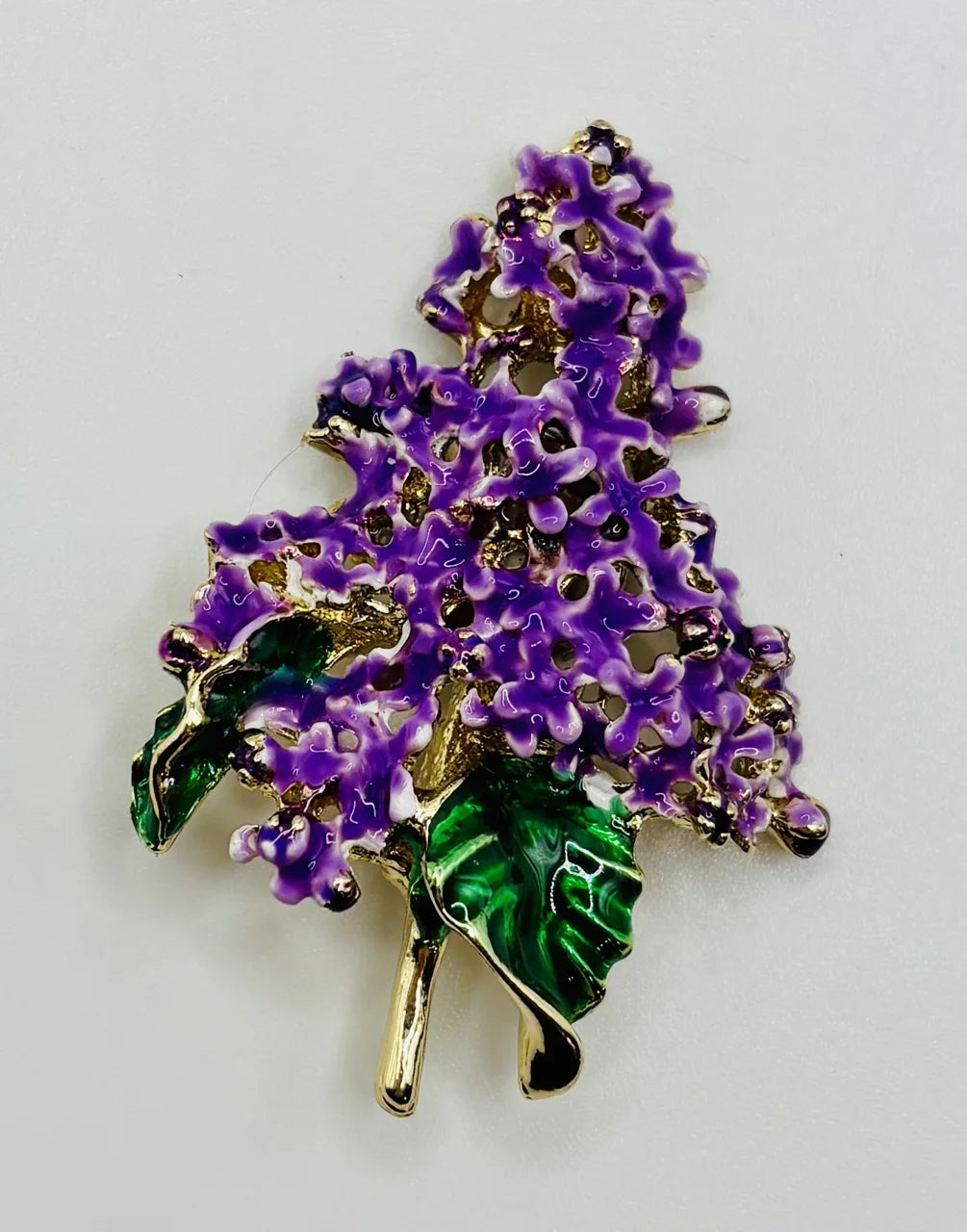 Enamel lavender lilac needle minder on a white background