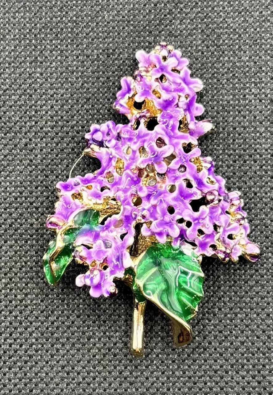 Enamel lavender lilac needle minder on dark fabric