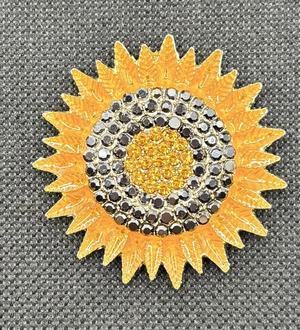 Crystal sunflower needle minder on dark fabric