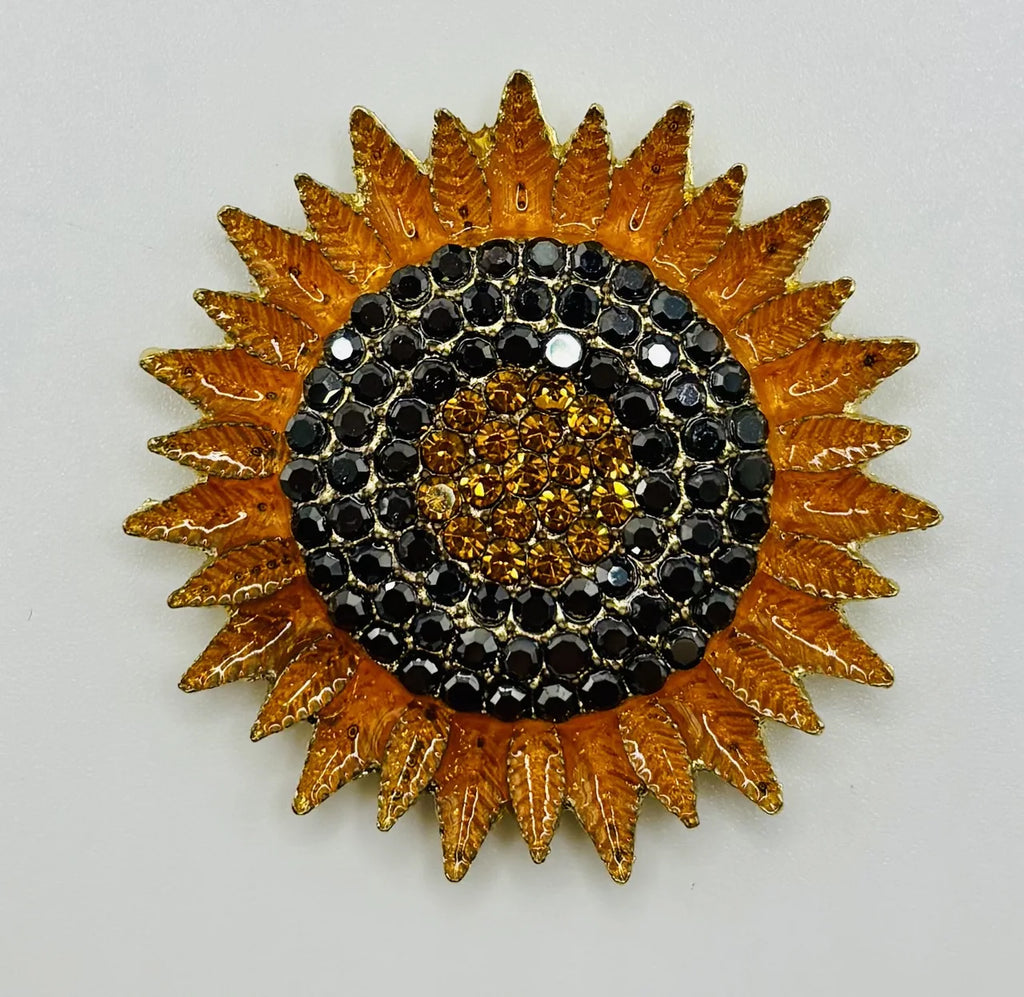Crystal sunflower needle minder on a white background
