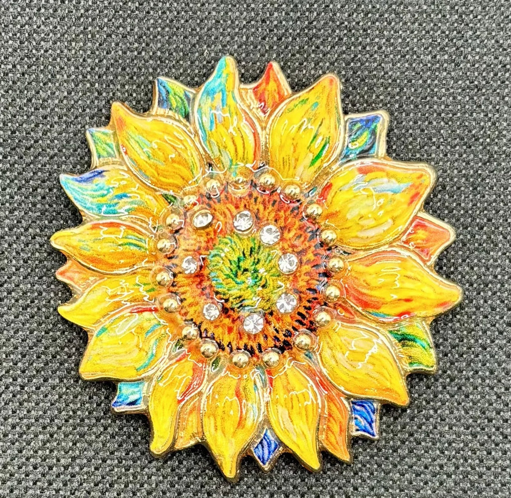 Oil dripped sunflower with crystal needle minder on dark fabric