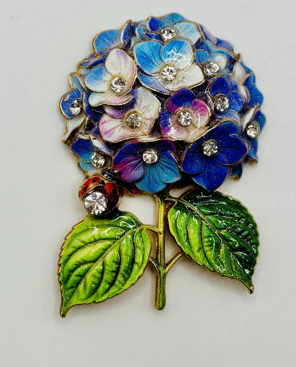 Blue and lavender hydrangea needle minder on a white background