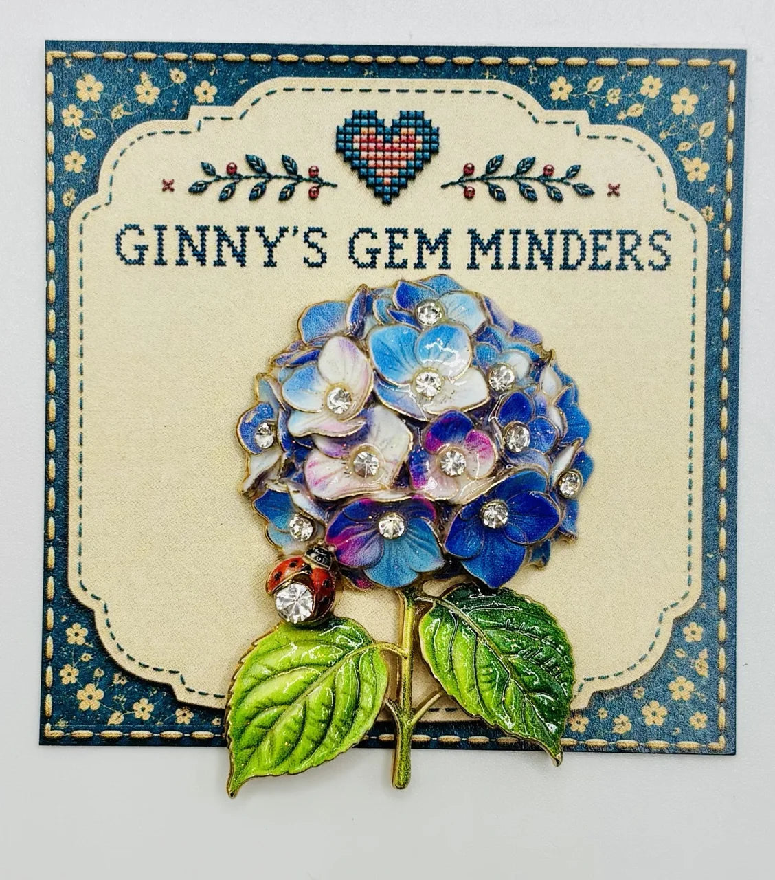 Blue and lavender hydrangea needle minder on Ginny’s Gem Minders display card