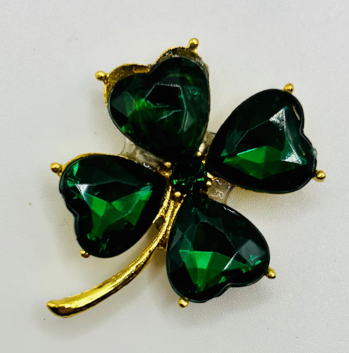 Small crystal shamrock needle minder on a white background