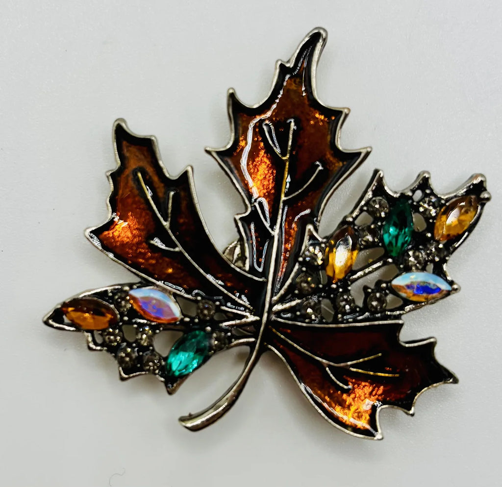Bronze crystal leaf needle minder on a white background
