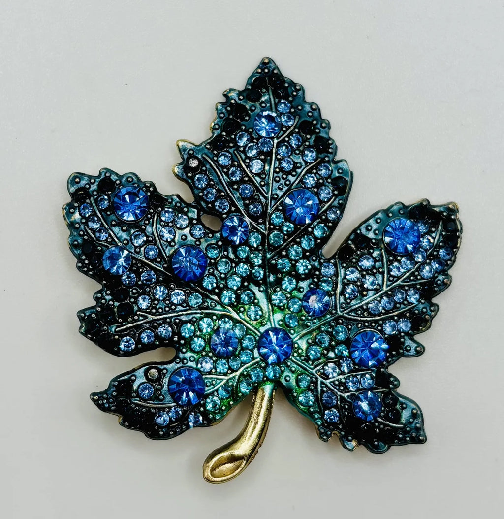 Blue crystal leaf needle minder on a white background