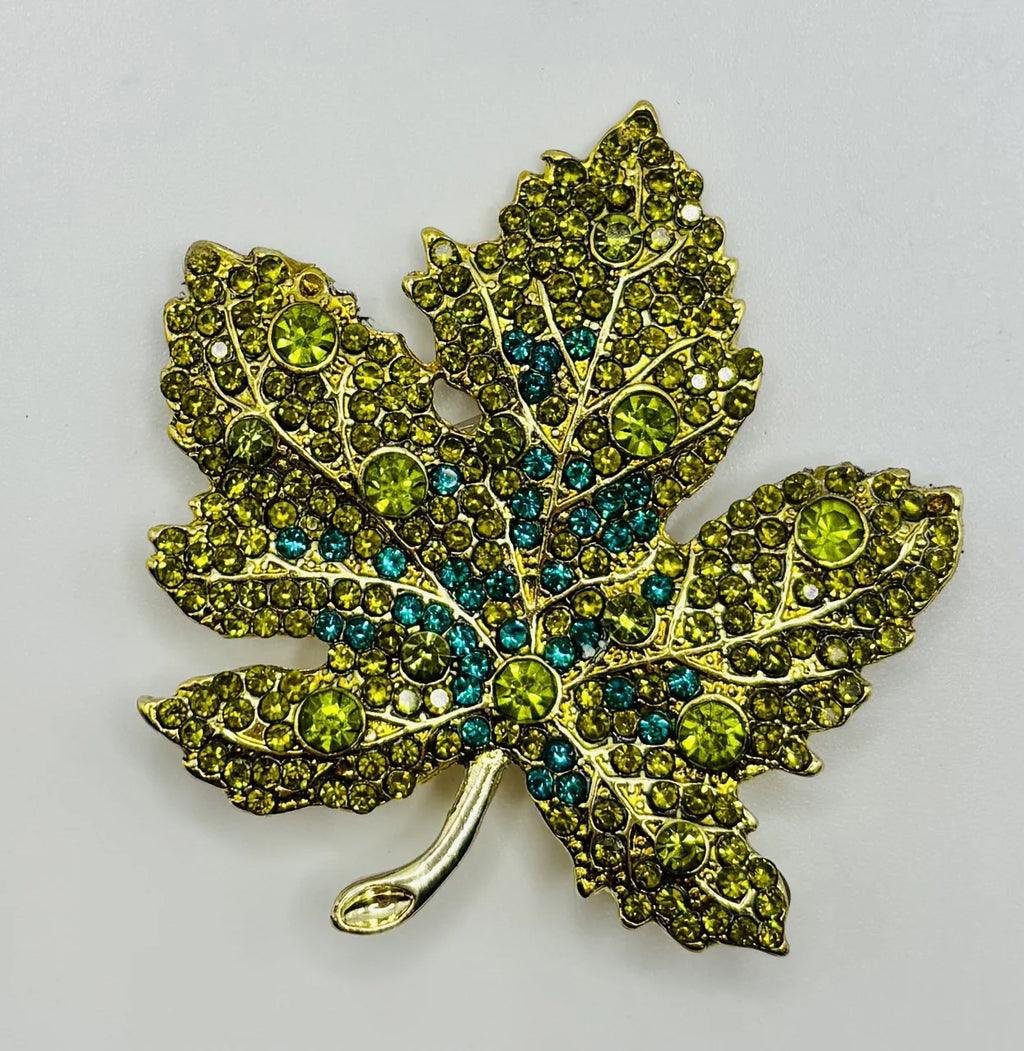 Green crystal leaf needle minder on a white background