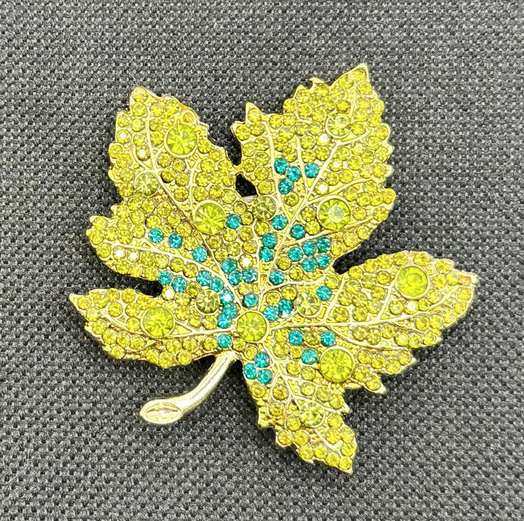 Green crystal leaf needle minder on dark fabric