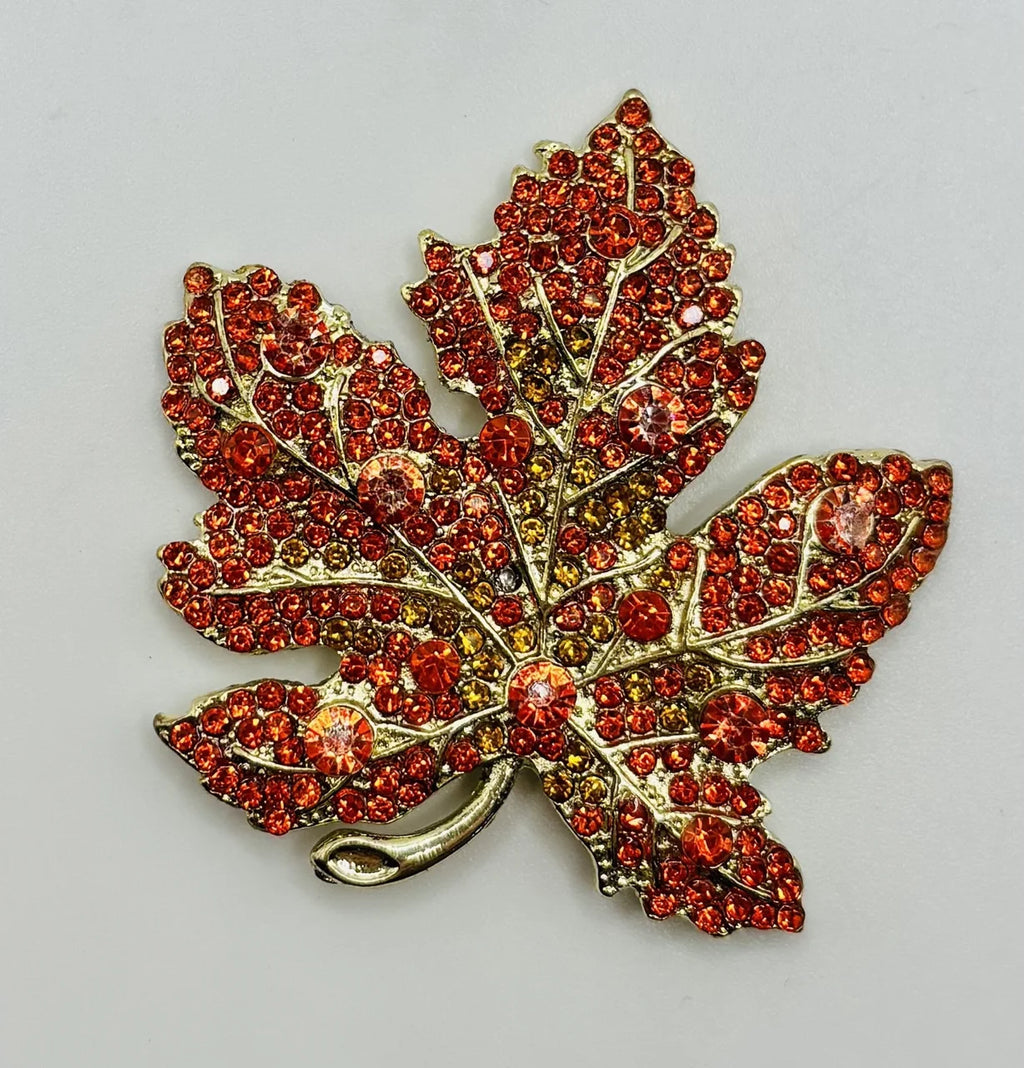 Orange crystal leaf needle minder on a white background