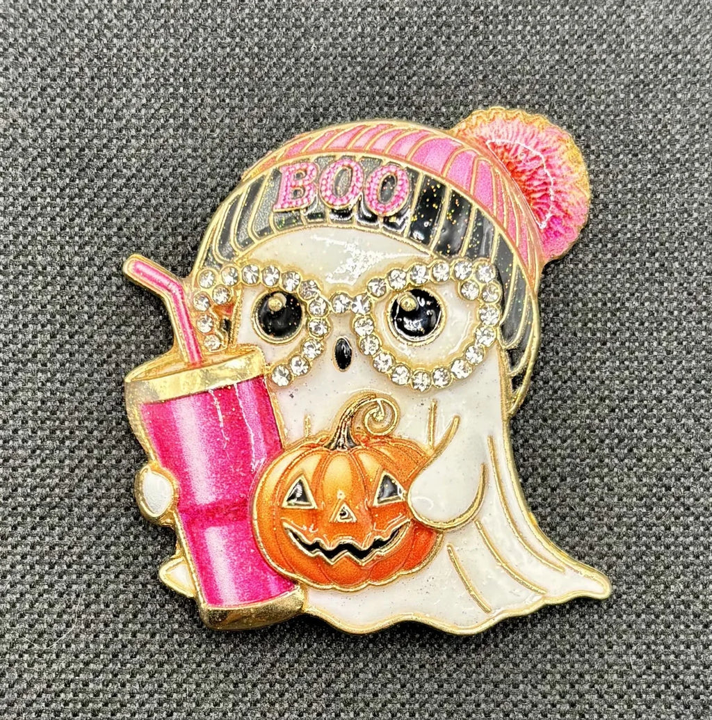 Enamel and crystal ghost girl needle minder on dark fabric