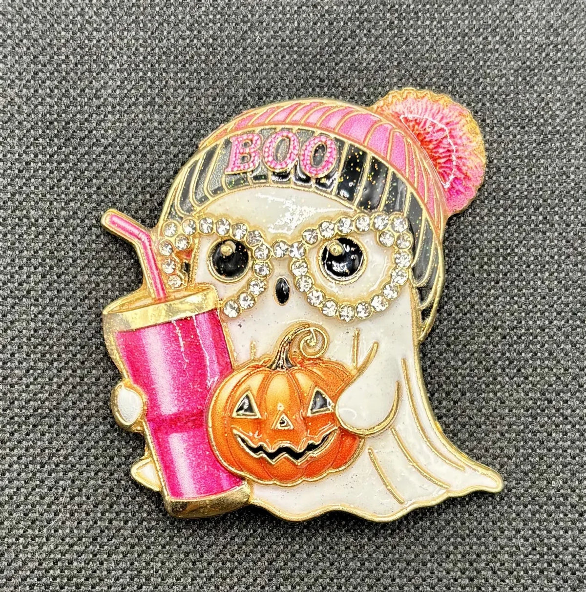 Enamel and crystal ghost girl needle minder on dark fabric