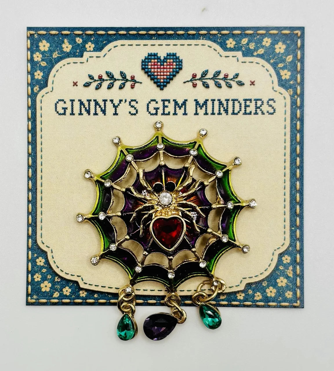 Jeweled spider in web needle minder on Ginny’s Gem Minders display card