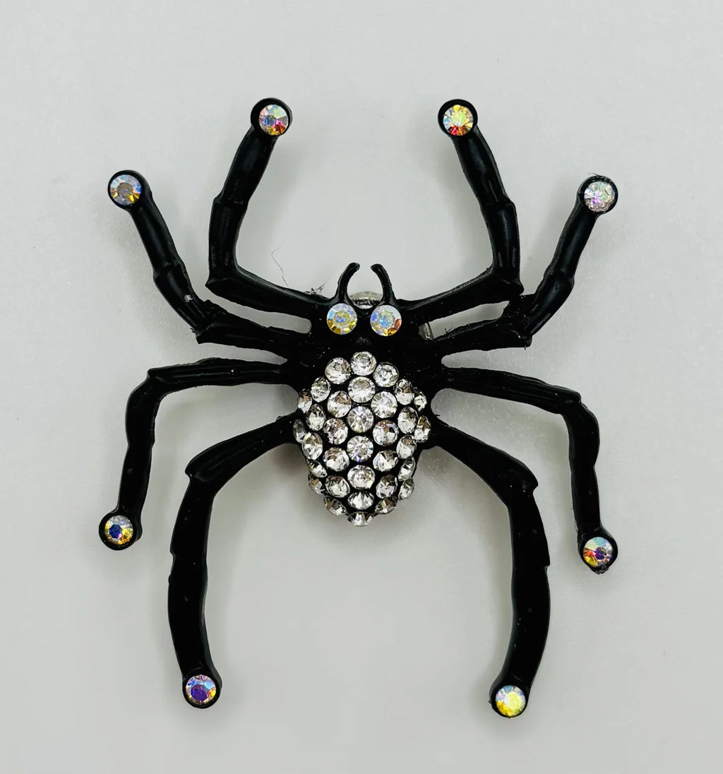 Black spider with crystals needle minder on a white background