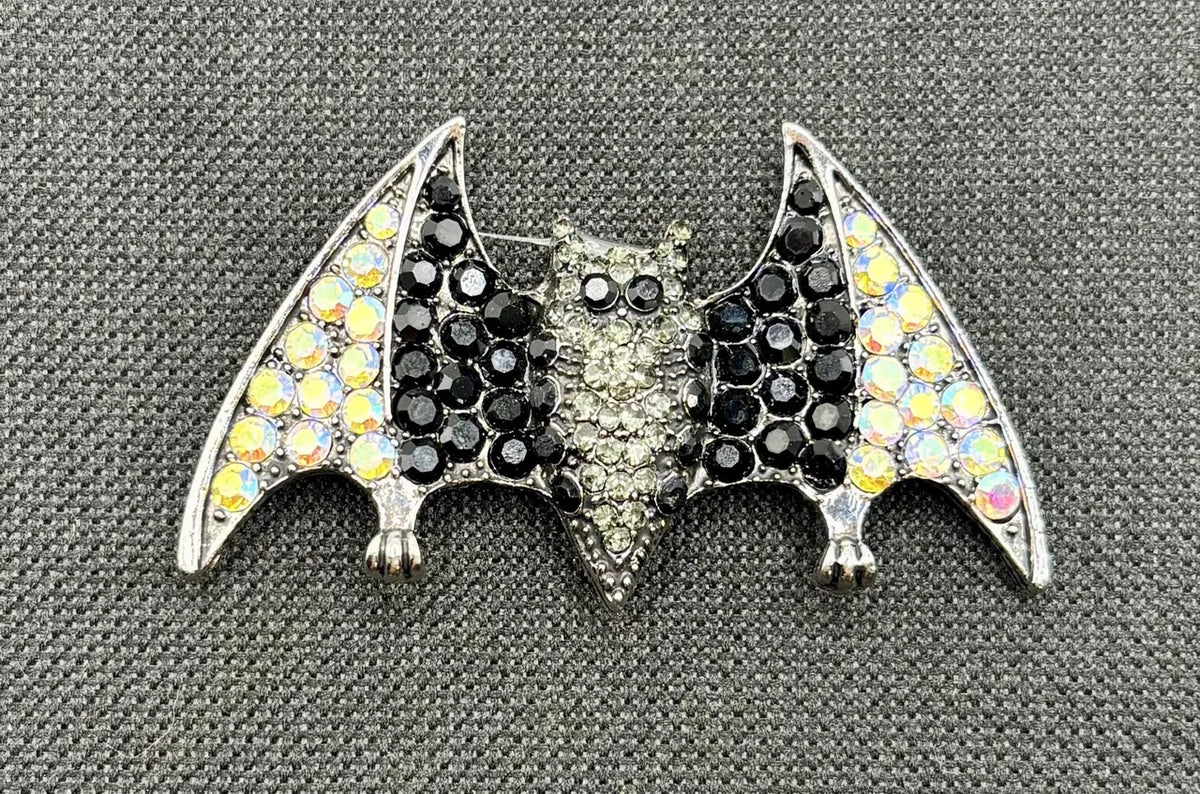 Crystal bat needle minder on dark fabric