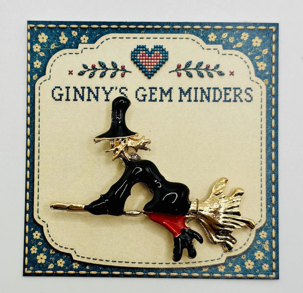 Enamel flying witch needle minder on Ginny’s Gem Minders display card