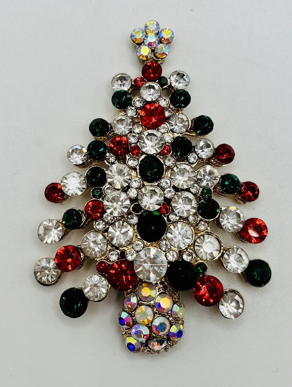 Crystal encrusted tree needle minder on a white background