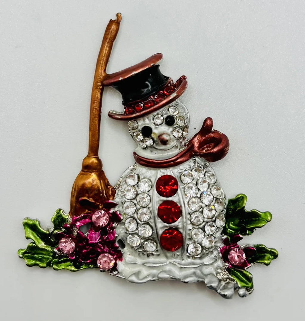 Snowman with broom needle minder on a white background