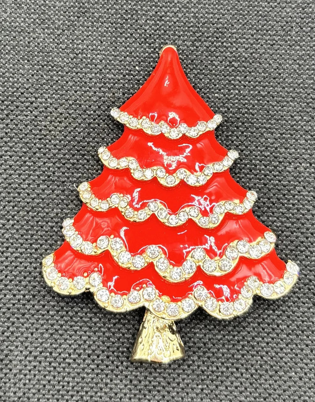 Red enamel tree with crystals needle minder on dark fabric