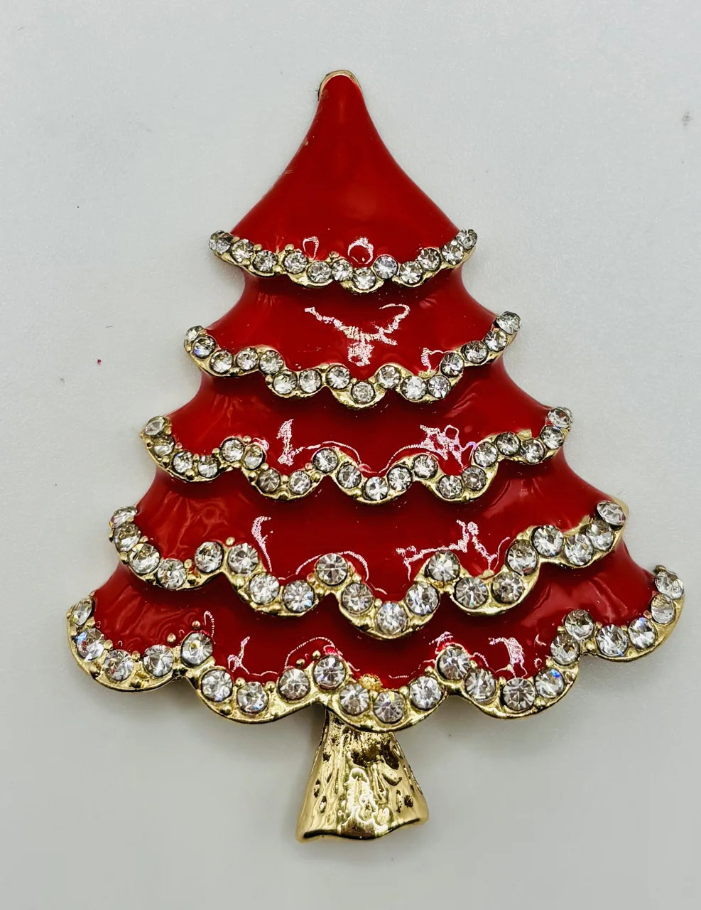 Red enamel tree with crystals needle minder on a white background