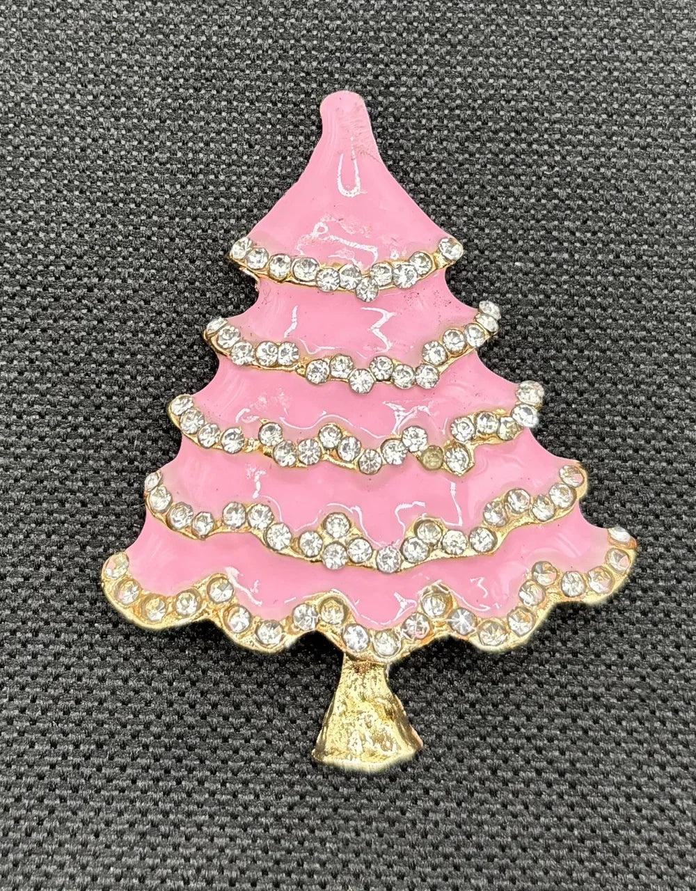 Pink enamel tree with crystals needle minder on dark fabric
