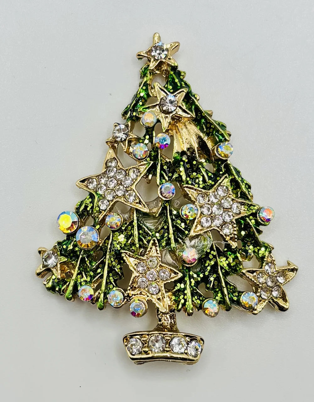 Green tree with crystal stars needle minder on a white background