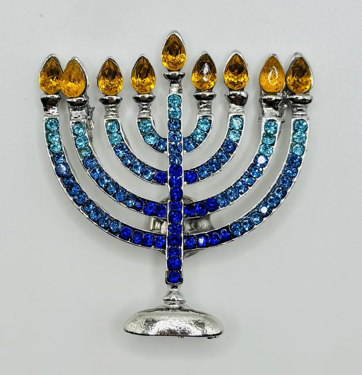 Crystal menorah needle minder on a white background
