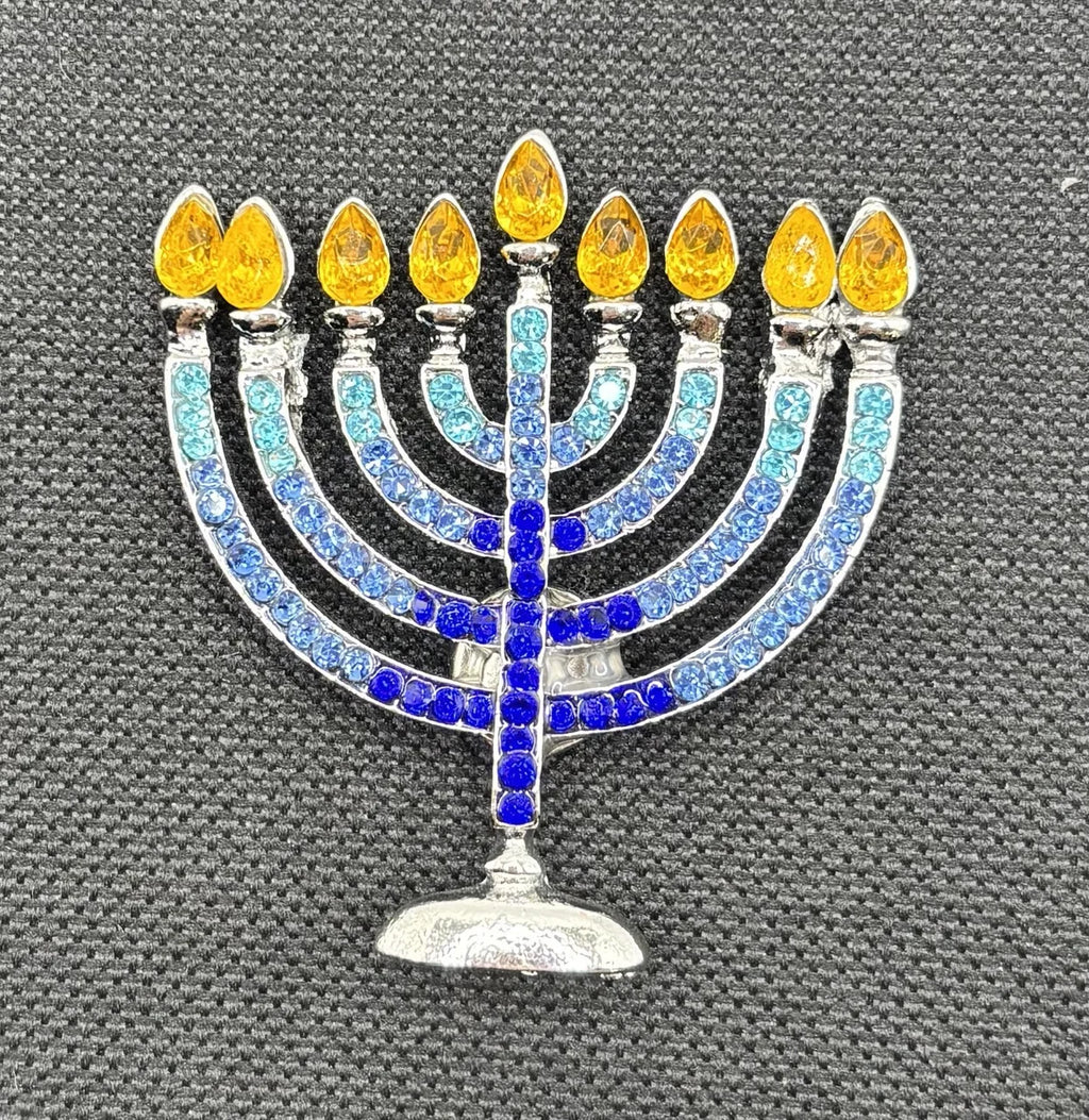 Crystal menorah needle minder on dark fabric