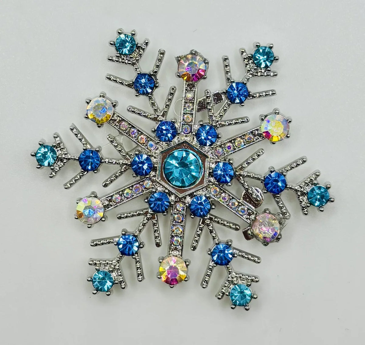 Blue crystal snowflake needle minder on a white background