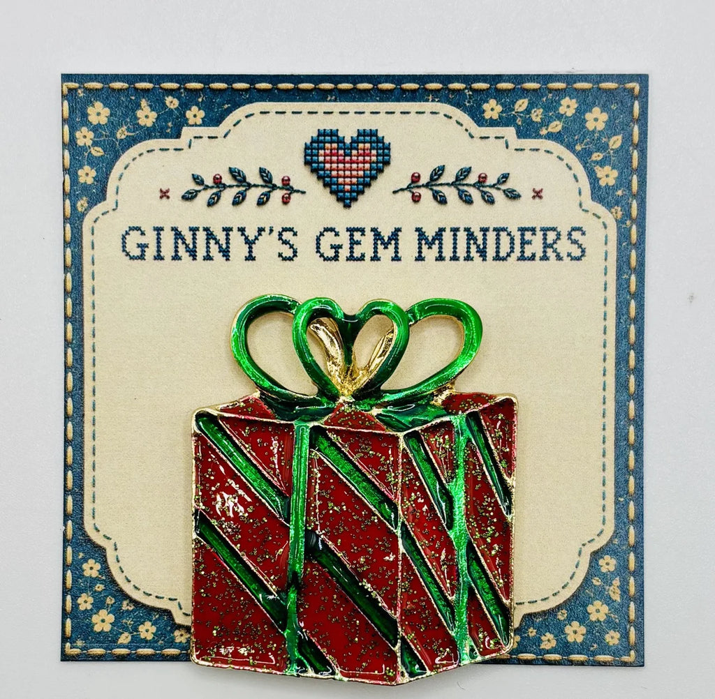 Red enamel present needle minder on Ginny’s Gem Minders display card
