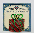 Red enamel present needle minder on Ginny’s Gem Minders display card