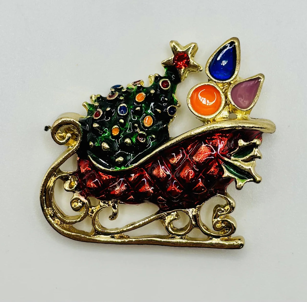 Enamel crystal sled needle minder on a white background